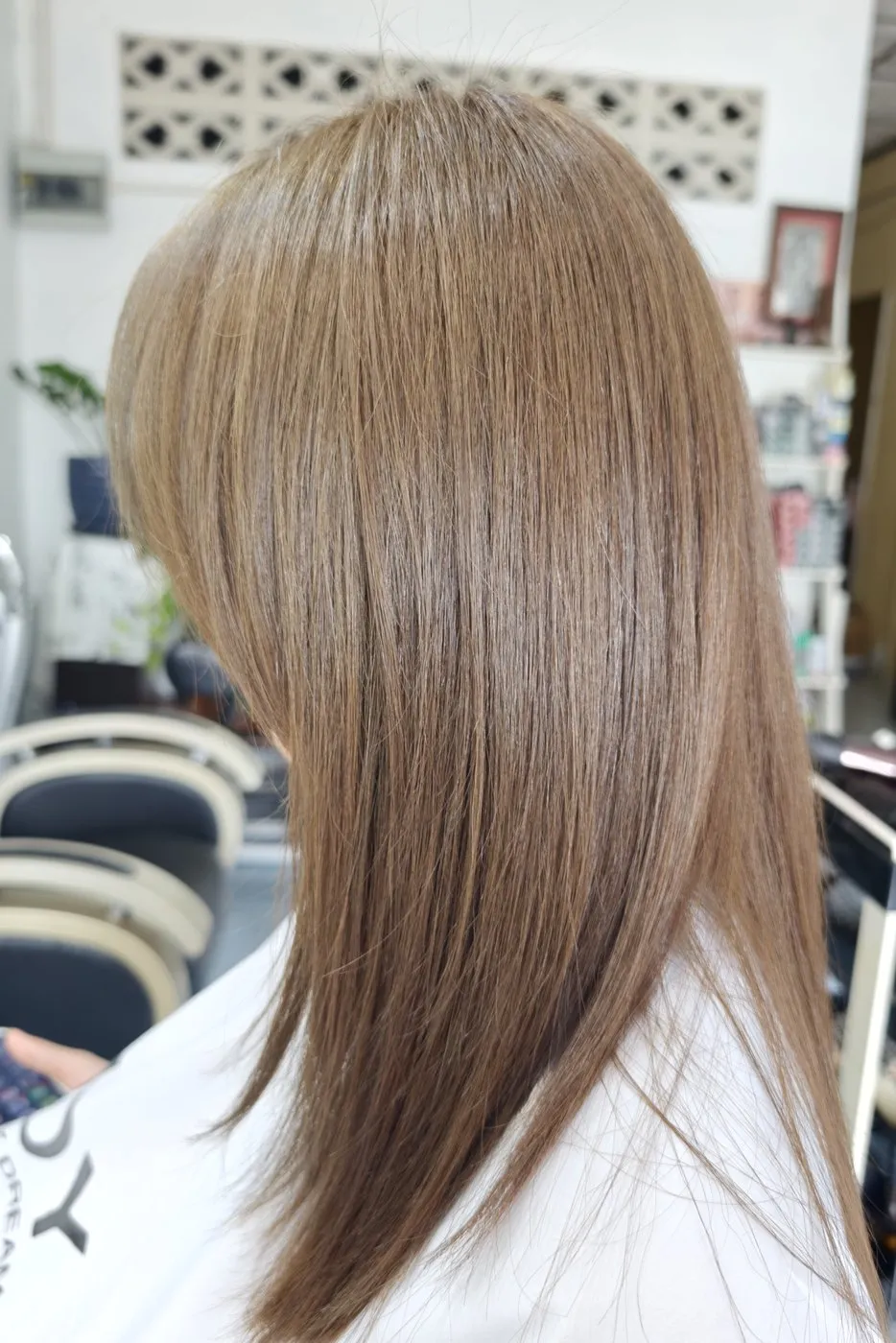 Straight, light ash brown hair, seen from the side