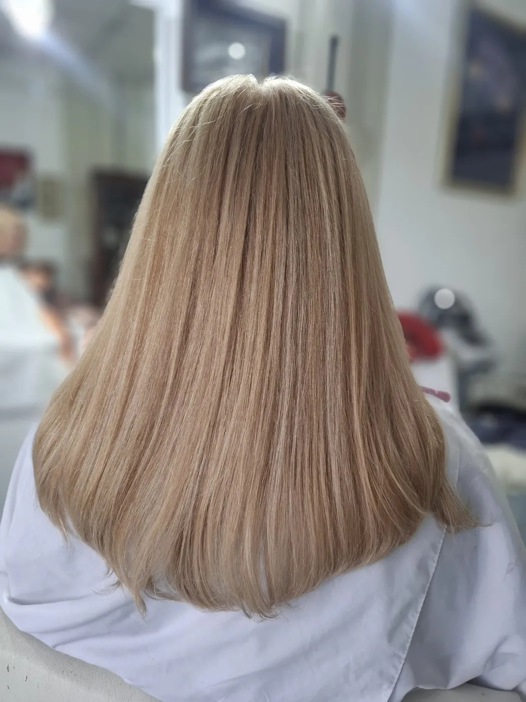 Straight, shoulder-length light blonde hair, from behind